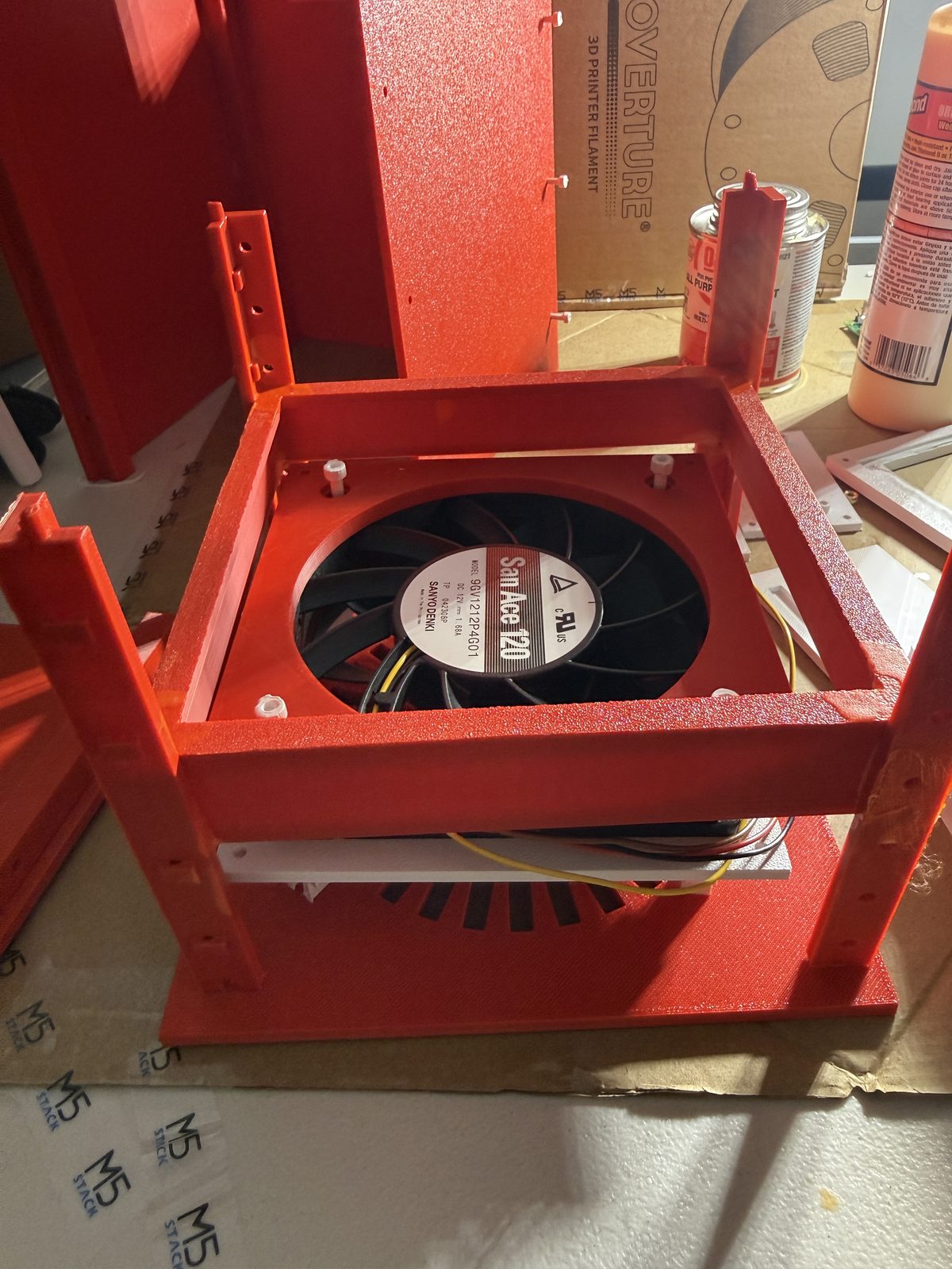 A 120 mm Sanyo Denki San Ace industrial fan dry-fitted into Linden's red 3D-printed internal frame.
